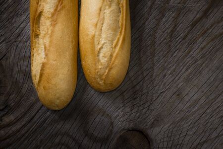 Bread on rustic wooden table with copy spaceの写真素材