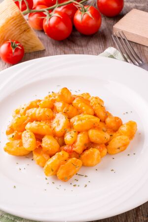 Potato gnocchi with tomato sauce and cheeseの写真素材