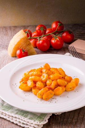 Potato gnocchi with tomato sauce and cheeseの写真素材