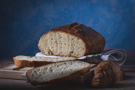 Homemade bread laid on a rustic table in a vintage settingの写真素材