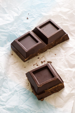 chocolate bars on crumpled paper, food closeup photoの写真素材