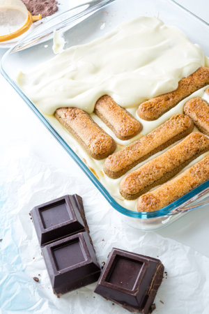 Traditional Italian Savoiardi ladyfingers Biscuits and chocolate on a white backgroundの写真素材