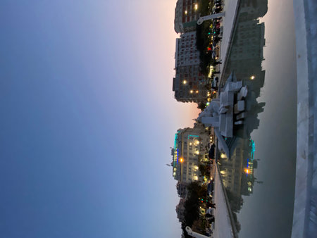 Urban sunset view of Pescara cityscape reflecting on water with monument, in Largo Mediterraneo, Abruzzo, Italyの写真素材