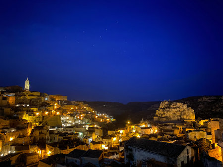 Matera's nocturnal landscape glowing under starry skies, Ursa Major constellation illuminating...
