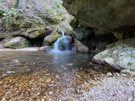 Stream flowing among the rocks with a small waterfall in the background, in the province of Pescaraの写真素材