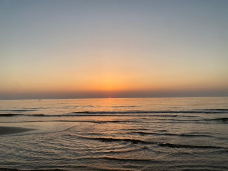 Golden sunrise illuminating tranquil waters near Pineto, coastal landscape in Abruzzo, Italy, revealing serene maritime sceneryの写真素材