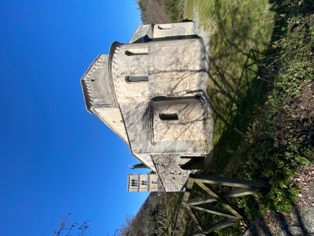 Historic San Liberatore a Majella Abbey rising dramatically beside mountain landscape, medieval highlighting Romanesque stone architecture under bright azure sky in Abruzzo regionの写真素材