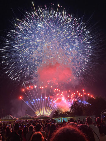 Colorful fireworks exploding over a crowd watching a pyrotechnic show in Largo Immacolata, Pescara, Abruzzo, Italyの写真素材