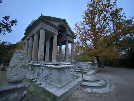 The Temple of the Muses stands majestically in Bomarzo, Italy, surrounded by autumn foliage, a testament to ancient Roman architectureの写真素材