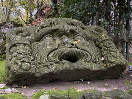 Weathered stone sculpture of Oceanus covered in moss, located in the fantastical Monster Park, Bomarzo, Lazio, Italyの写真素材