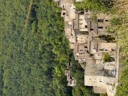 Clustered stone houses form the heart of Carapelle Calvisio, Italy, a picturesque village in Abruzzo, surrounded by lush greeneryの写真素材