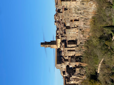 Pitigliano, a picturesque medieval village perched on a tufa cliff in Tuscany, Italy, showcases its stunning architecture against a clear blue skyの写真素材