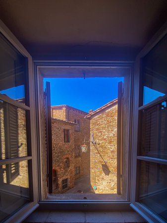 Sunlight illuminating charming alley in Civitella in Val di Chiana, as seen from an open window,...
