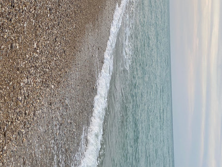 Soft waves gently lapping on the pebble beach of Pineto in Abruzzo, Italy, creating a tranquil and serene atmosphereの写真素材