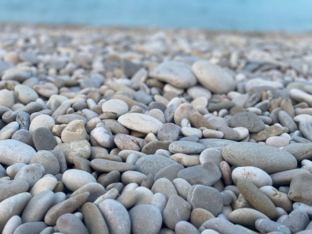Smooth pebbles form a natural mosaic on the beach of Pineto, Abruzzo, Italy, offering a tranquil backdrop of coastal serenityの写真素材