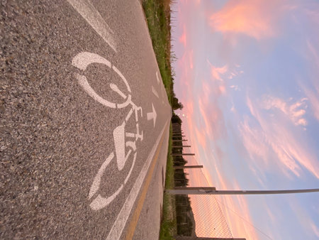 Bike path winding through coastal landscape, golden sunset illuminating scenic route in Pineto, Abruzzo, Italyの写真素材