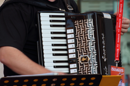 Ferrara, Italia - August 25, 2016: The Ferrara Buskers Festival is dedicated to the art of the street. A small detail of a Soprani accordion used by a street bandのeditorial素材