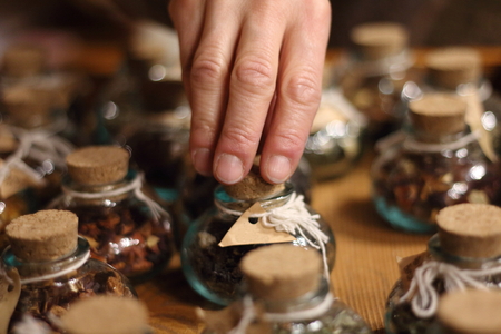 assortment of fragrant dried teas and other spice on wooden table,の写真素材