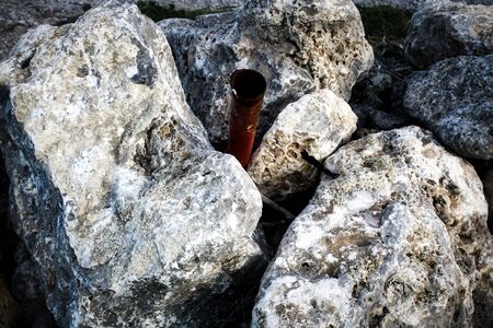 Rusted pipe and valve on a forgotten beach.winter seaの写真素材