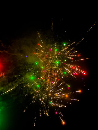 Colorful fireworks on black sky background. Holiday celebration and happiness concept.