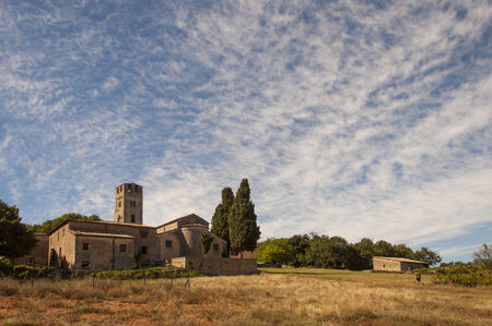 wonderful church surrounded by the hills of the tuscan countrysideの写真素材