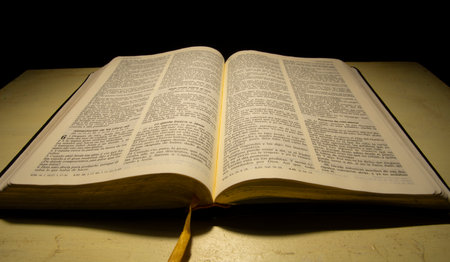 open bible reflected with warm lightの写真素材