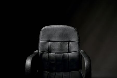 Empty, black leather office chair.の写真素材