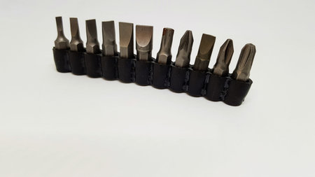 A row of screwdriver adapters in a black rubber holder