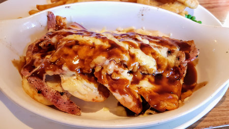 Chicken breast topped with bacon, cheese and BBQ sauce.