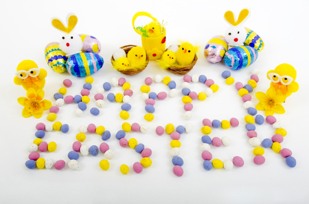 Mini Easter eggs spelling the words Happy Easter with a selection of Easter Duck and Rabbit  novelties.の写真素材