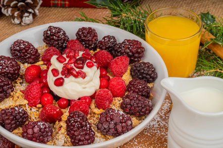 Festive dish of breakfast cereal with fresh berries, fruit and topped with natural Yogurt.