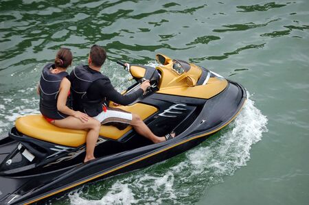 Teenaged Boy and Girl on a Slow Moving Jetskiの写真素材
