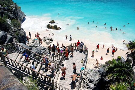 Wooden stairway winding down from cliffs overlooking a white sand beach in Tulum,Mexico a popular cruise ship tour destination .のeditorial素材