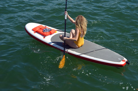 Woman rowing on a paddle board off Miami Beach on the florida intra-coastal waterway