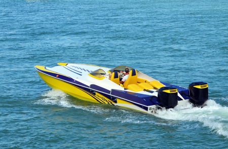 Sleek aerodynamic speed boat powered by two outboard engines.の写真素材