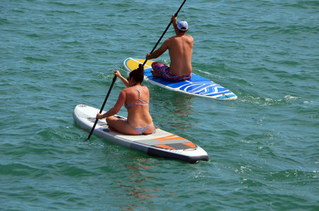 Man and a woman paddle boarding on Biscayne Bay off Miami Beach,Florida
