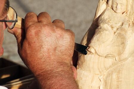 a craftsman makes from wood a sculptureの写真素材