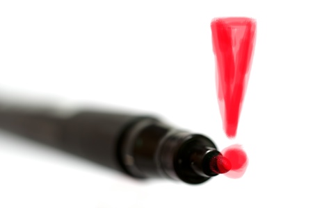 A red exclamation mark painted with a felt pen on a glass wallの写真素材