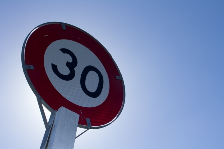Speed limit sign for restricted zone in urban areas of 30 kmhの写真素材