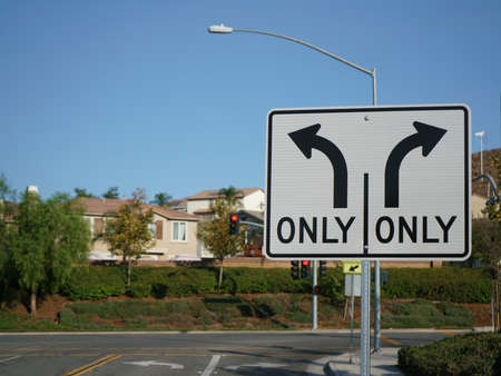 A Turn Only Road Sign with intersection in backgroundの写真素材