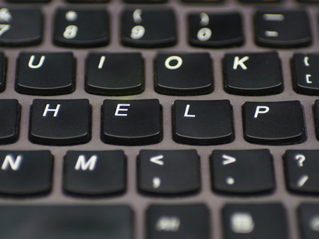 Computer keyboard with keys spelling out the word help.