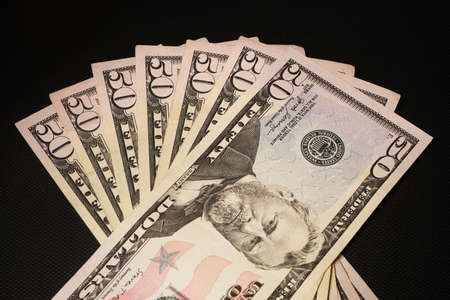 US 50dollar notes fanned out on black background.の写真素材