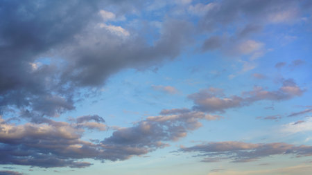 Dark cloud moving in under blue skies