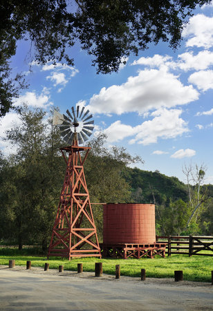 Red Windmill and water tank under beautiful blue skies.の写真素材
