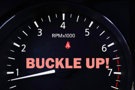 Orange fasten seat beat indicator light on dashboard with reminder message.
