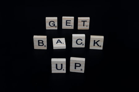 Lake Elsinore, CA, USA - September 17, 2023: Scrabble tiles isolated on black background spelling...
