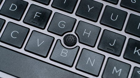 laptop keyboard with focus on pointing stick track point