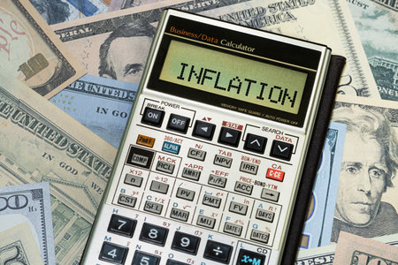 Financial calculator with word inflation on US currencyの写真素材