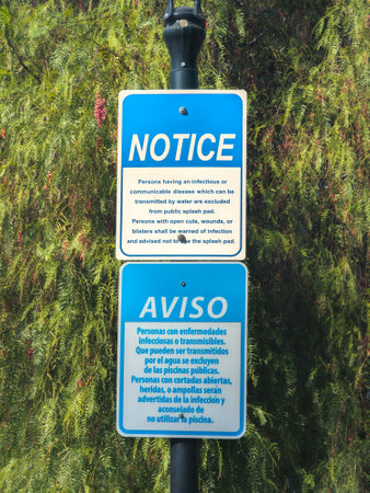 Health advisory sign at public splashpad in English and Spanishの写真素材