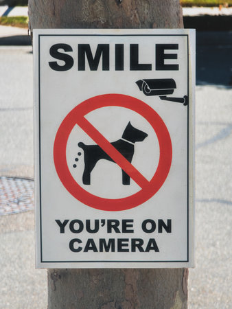 Smile You're on Camera dog poop signの写真素材